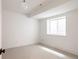 Bright, minimalist bedroom with white walls and a window providing natural light at 4131 Quivas St, Denver, CO 80211