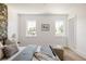 Light-filled bedroom featuring white walls, hardwood floors, a cozy bed, and modern furnishings at 4131 Quivas St, Denver, CO 80211