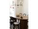 Bright dining room with a sleek table, modern chandelier, and a black and white rug at 4131 Quivas St, Denver, CO 80211