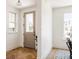 Inviting entryway with herringbone wood floors, natural light, and a view of the neighborhood at 4131 Quivas St, Denver, CO 80211
