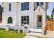 Charming white brick home with front porch, inviting entry, and manicured lawn at 4131 Quivas St, Denver, CO 80211