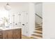 Hallway with white walls, a wooden island, and stairs with a wooden handrail at 4131 Quivas St, Denver, CO 80211