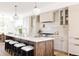 Spacious kitchen featuring an island with stools, stylish pendant lighting and modern appliances for cooking at 4131 Quivas St, Denver, CO 80211