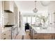 Bright and modern kitchen with stainless steel appliances, hardwood floors, and an open layout at 4131 Quivas St, Denver, CO 80211