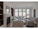 Bright living room features a fireplace, built-in bookshelves, and sliding glass doors to outdoor balcony at 4131 Quivas St, Denver, CO 80211