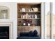 Charming living room with wooden shelves, decorative items, and a comfortable blue sofa at 4131 Quivas St, Denver, CO 80211