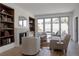 Bright living room boasts a fireplace, built-in bookshelves, and sliding glass doors to outdoor balcony at 4131 Quivas St, Denver, CO 80211
