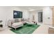 A well-decorated living room features a plush gray sectional sofa, modern art, and a bright green rug at 4131 Quivas St, Denver, CO 80211