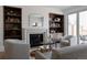 Bright living room offers a fireplace, built-in bookshelves, and sliding glass doors to an outdoor balcony at 4131 Quivas St, Denver, CO 80211
