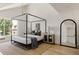 Spacious main bedroom with a four-poster bed, a jute rug, and a modern design at 4131 Quivas St, Denver, CO 80211