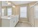 Bathroom with double sink vanity, tiled floor, and glass shower at 18399 Field Mint Pt, Parker, CO 80134