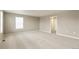 Spacious bedroom with neutral carpet, a large window, and doorway at 18399 Field Mint Pt, Parker, CO 80134