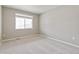 Neutral bedroom features a large window providing natural light and plush carpet at 18399 Field Mint Pt, Parker, CO 80134