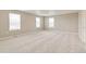 Bright and airy bedroom with plush carpet and large windows offering natural light at 18399 Field Mint Pt, Parker, CO 80134