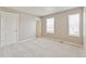 Bright bedroom with two windows, neutral carpet, and a closet at 18399 Field Mint Pt, Parker, CO 80134