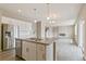 Bright kitchen with stainless steel appliances, an island sink, and an open-concept layout at 18399 Field Mint Pt, Parker, CO 80134