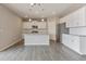 Modern kitchen featuring white cabinets, stainless steel appliances, and an island with a sink at 18399 Field Mint Pt, Parker, CO 80134