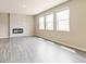 Spacious living room features contemporary fireplace and large windows, offering a blend of modern style and natural light at 18399 Field Mint Pt, Parker, CO 80134
