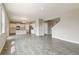 Open-concept area with view to kitchen that features sleek gray floors and plenty of natural light, ideal for modern living at 18399 Field Mint Pt, Parker, CO 80134