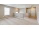 Spacious loft area with neutral carpet, natural light, and staircase at 18399 Field Mint Pt, Parker, CO 80134