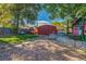 Expansive backyard featuring a large shed, mature trees, and a playful outdoor space at 1591 S Zuni St, Denver, CO 80223