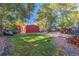 Expansive backyard featuring a large shed, mature trees, and a playful outdoor space at 1591 S Zuni St, Denver, CO 80223