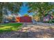 Spacious backyard featuring a large shed, mature trees, playhouse, and plenty of outdoor space at 1591 S Zuni St, Denver, CO 80223