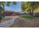 Spacious backyard with a mixture of stones and grass, featuring a charming white picket fence and mature trees at 1591 S Zuni St, Denver, CO 80223