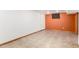 Unfurnished basement area featuring painted accent wall and tile flooring at 1591 S Zuni St, Denver, CO 80223