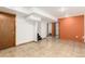 Finished basement showcasing open layout with tile floors, painted walls, and access to staircase at 1591 S Zuni St, Denver, CO 80223