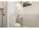 Modern bathroom with tiled shower, updated vanity, and contemporary fixtures at 1591 S Zuni St, Denver, CO 80223