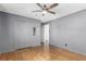 Spacious bedroom featuring hardwood floors, a ceiling fan and fresh paint, creating a serene retreat at 1591 S Zuni St, Denver, CO 80223