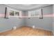 Bright bedroom with hardwood floors, fresh paint and abundant natural light from multiple windows at 1591 S Zuni St, Denver, CO 80223