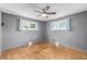 Inviting bedroom with hardwood floors, fresh paint and abundant natural light from multiple windows at 1591 S Zuni St, Denver, CO 80223