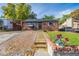 Inviting brick home with tidy front yard, sidewalk, and covered parking for a cozy and functional appeal at 1591 S Zuni St, Denver, CO 80223