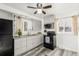 Updated kitchen with gray cabinets, modern appliances, stylish countertops, and modern flooring at 1591 S Zuni St, Denver, CO 80223