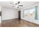 Bright living room featuring hardwood floors, fresh paint, ceiling fan and a large window providing ample natural light at 1591 S Zuni St, Denver, CO 80223