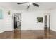 Open living room featuring hardwood floors, fresh paint, ceiling fan and built in shelving, creating a cozy atmosphere at 1591 S Zuni St, Denver, CO 80223