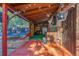 Covered patio ideal for relaxing, with view of the backyard featuring a trampoline and mature trees at 1591 S Zuni St, Denver, CO 80223