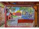 Covered patio with a swing offering serene view of the backyard, enhancing outdoor relaxation at 1591 S Zuni St, Denver, CO 80223