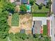 Aerial view of the property showcasing the pool, tennis court, backyard, and a long driveway at 10197 E Mississippi Ave, Aurora, CO 80247