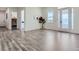 Spacious foyer with gray wood-look floors, a large window, white walls, and an open doorway at 10197 E Mississippi Ave, Aurora, CO 80247