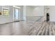 Inviting foyer with gray wood-look floors, large windows, white walls, and a wooden staircase at 10197 E Mississippi Ave, Aurora, CO 80247