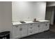 The kitchenette features quartz countertops, white cabinets, and black appliances at 10197 E Mississippi Ave, Aurora, CO 80247