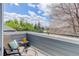 Private balcony with seating, offering an outdoor retreat with tree and neighborhood views at 8500 E Jefferson Ave # 3H, Denver, CO 80237