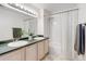 Bright bathroom featuring a double sink vanity and a shower-tub combination at 8500 E Jefferson Ave # 3H, Denver, CO 80237