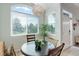 The dining area features a large arched window, wood-look floors and space for a four-person dining set at 8500 E Jefferson Ave # 3H, Denver, CO 80237