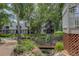 A charming exterior view showcasing lush greenery and walkways connecting residential buildings at 8500 E Jefferson Ave # 3H, Denver, CO 80237