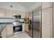 Well-equipped kitchen with modern stainless steel appliances, ample cabinet space, and functional layout at 8500 E Jefferson Ave # 3H, Denver, CO 80237