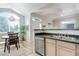 Bright kitchen features stainless steel appliances, double sink, and access to the dining area with beautiful arched window at 8500 E Jefferson Ave # 3H, Denver, CO 80237